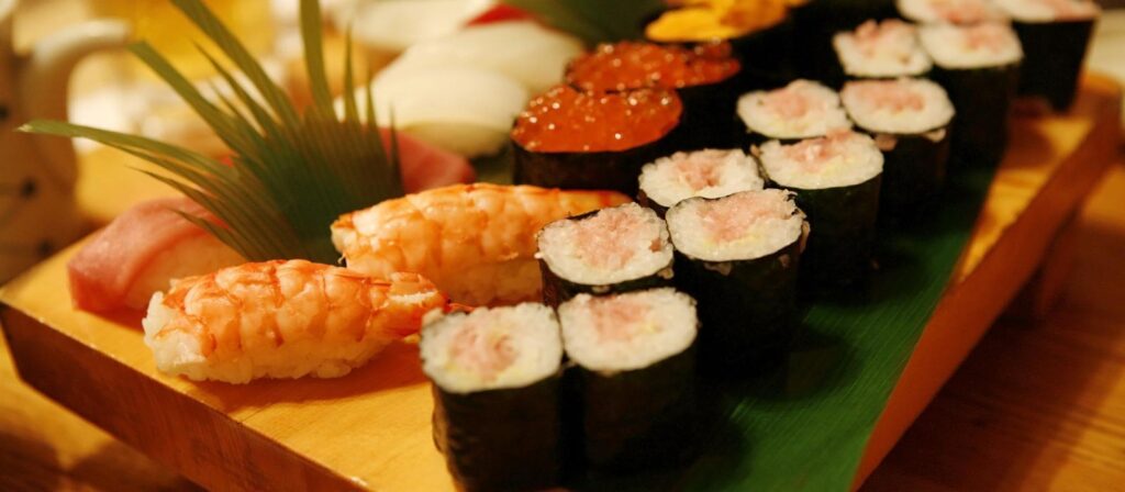 Various sushi on wooden platter at Dragon Star Buffet